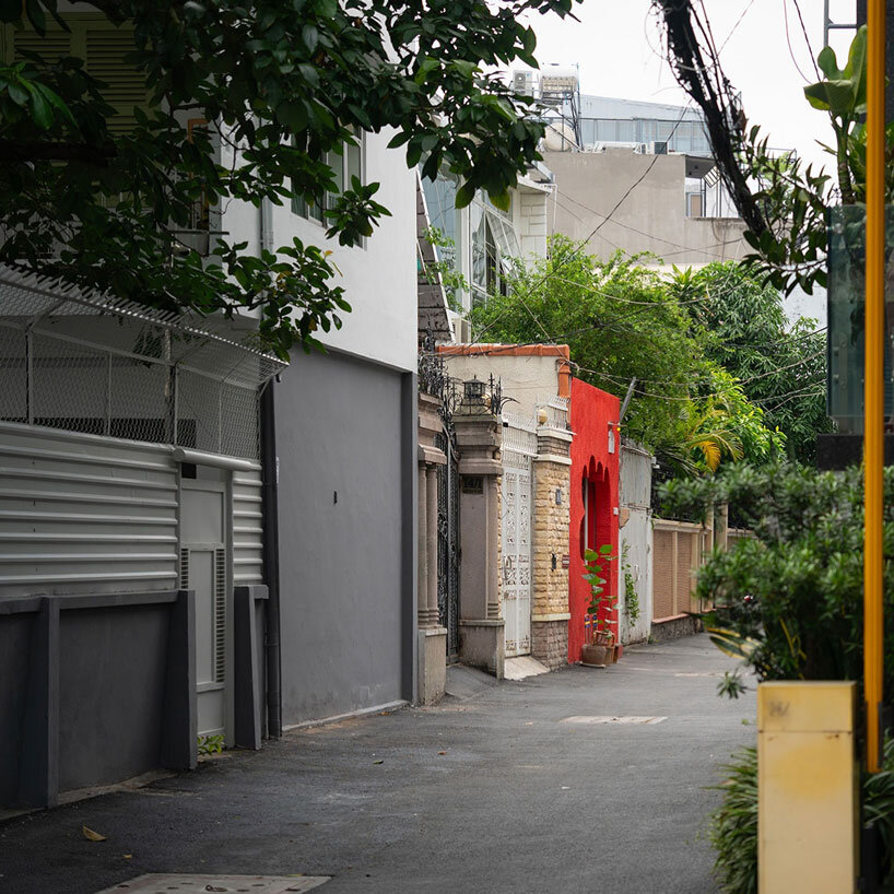 café’s red facade carves welcoming hand-shaped entrance in vietnam