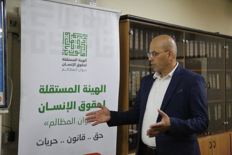 Farid al-Atrash stands in front of a banner