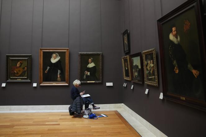 A woman draws in the Richelieu gallery of Le Louvre museum are seen Wednesday, November 19, 2025 in Paris.