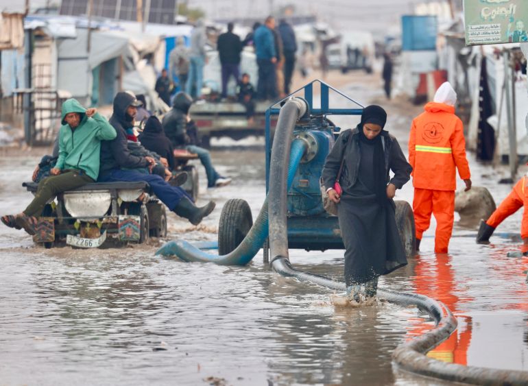Workers drain floodwaters in Gaza's al-Mawasi camp