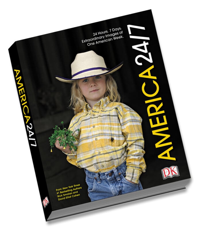 A book titled "AMERICA 24/7" featuring a young child in a yellow plaid shirt, blue jeans, and a cowboy hat holding greenery on the cover. The background is dark, and the publisher's DK logo appears on the bottom right.