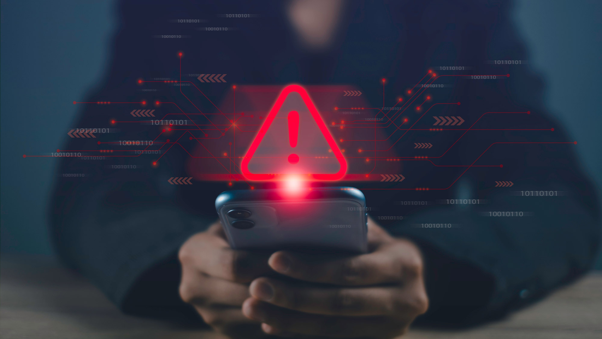 A person looking at a phone with a digital warning sign over it