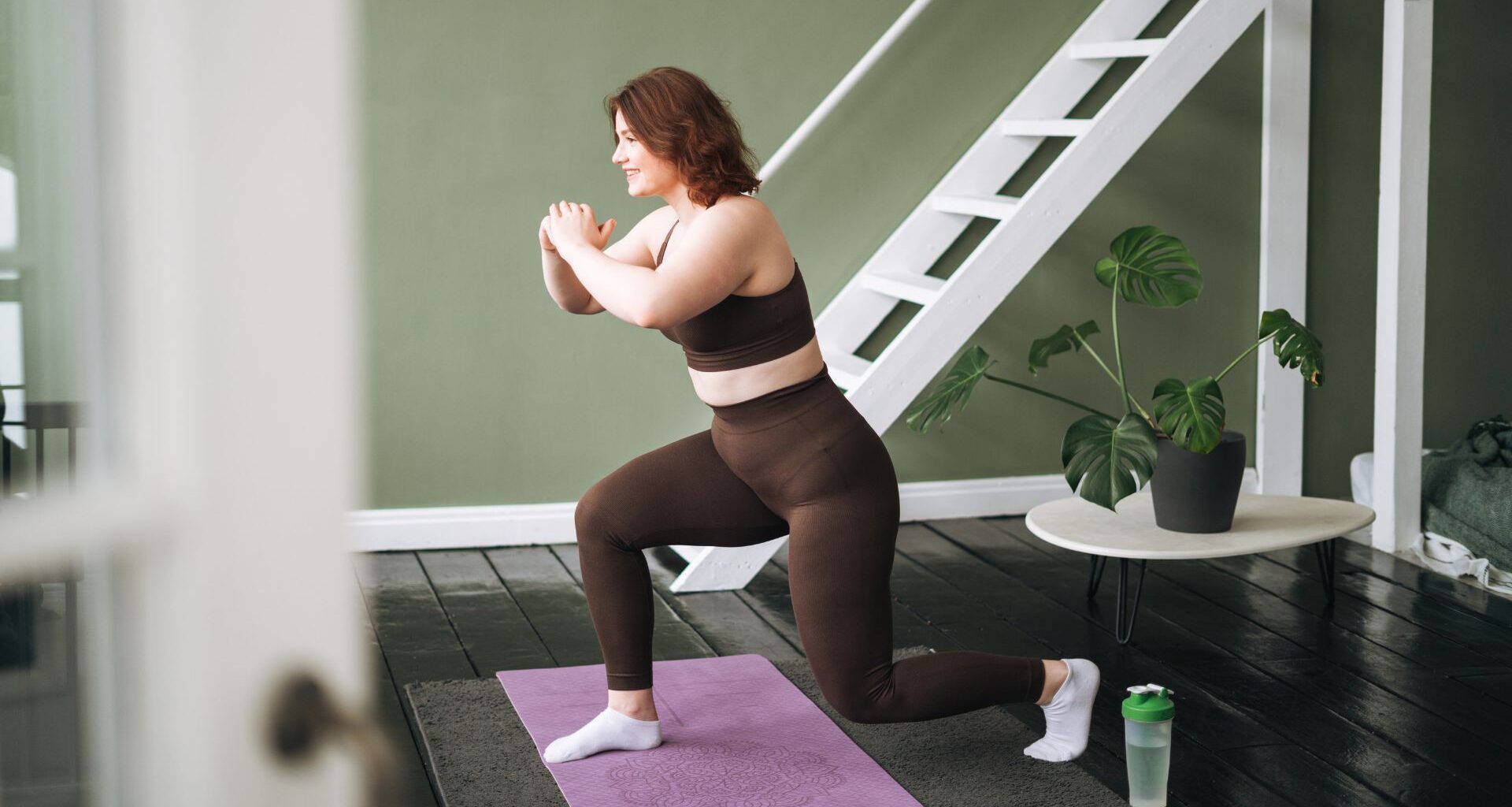 Woman doing deep core exercises on yoga mat at home