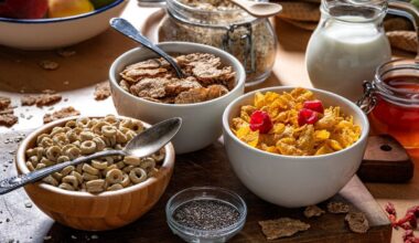 A selection of breakfast cereals on a messy table with milk