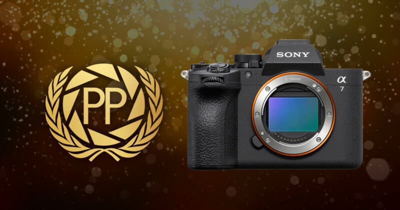 A Sony Alpha 7 camera next to a gold laurel wreath badge with the letters "PP" on a sparkling, bokeh background.