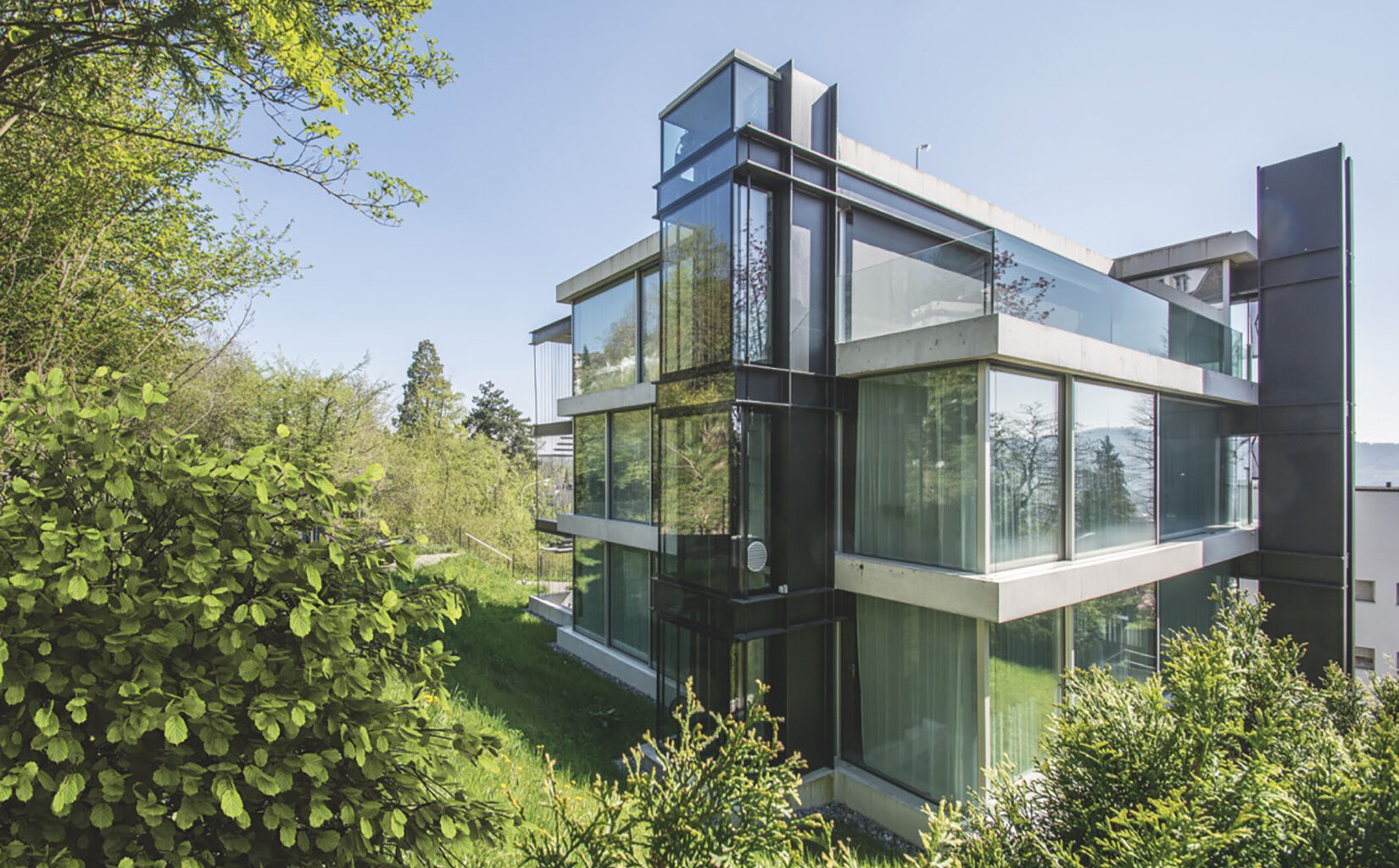 A radical hillside house suspends living space above residential Zurich