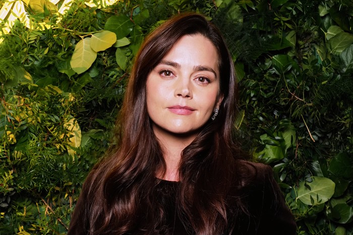 Jenna Coleman, wearing a black dress.