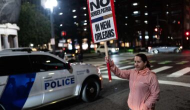 A woman holds a sign during a protest against the U.S. Border Patrol and Immigration and Customs Enforcement (ICE) outside of Hale Boggs Federal Building in New Orleans, Louisiana, on December 6, 2025.