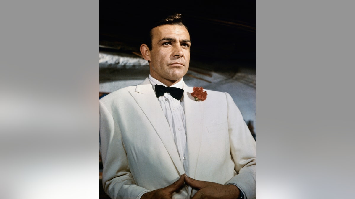 Sean Connery as James Bond in a white suit and bowtie.