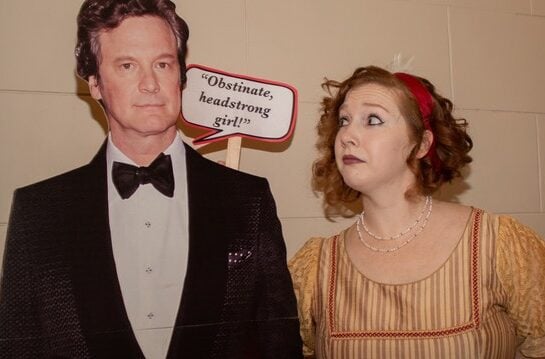 A woman in period dress poses next to a cardboard cutout of Colin Firth, the actor who starred in the BBC's 1995 adaptation of Jane Austen's ‘Pride & Prejudice.’