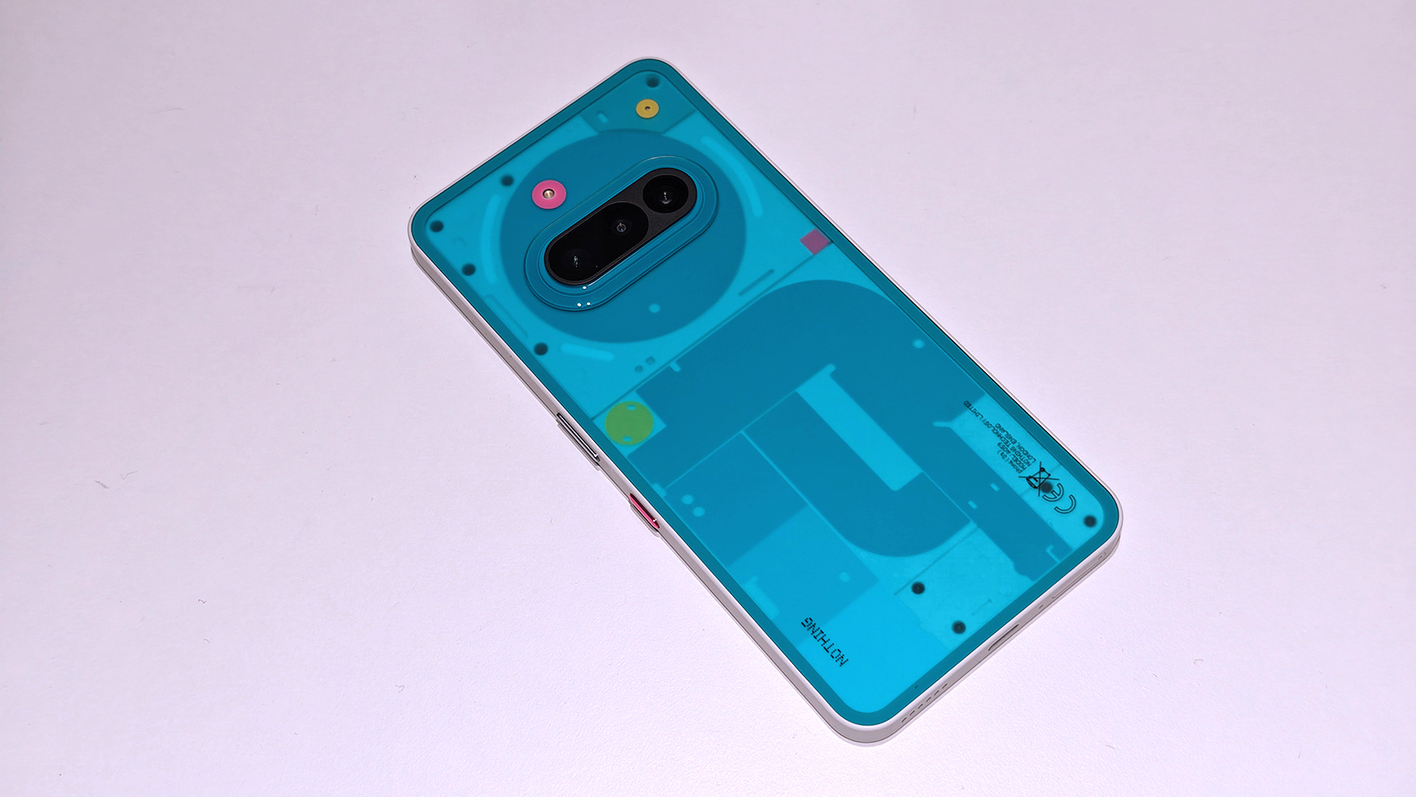 Nothing 3a Community Edition, a green phone on a white table