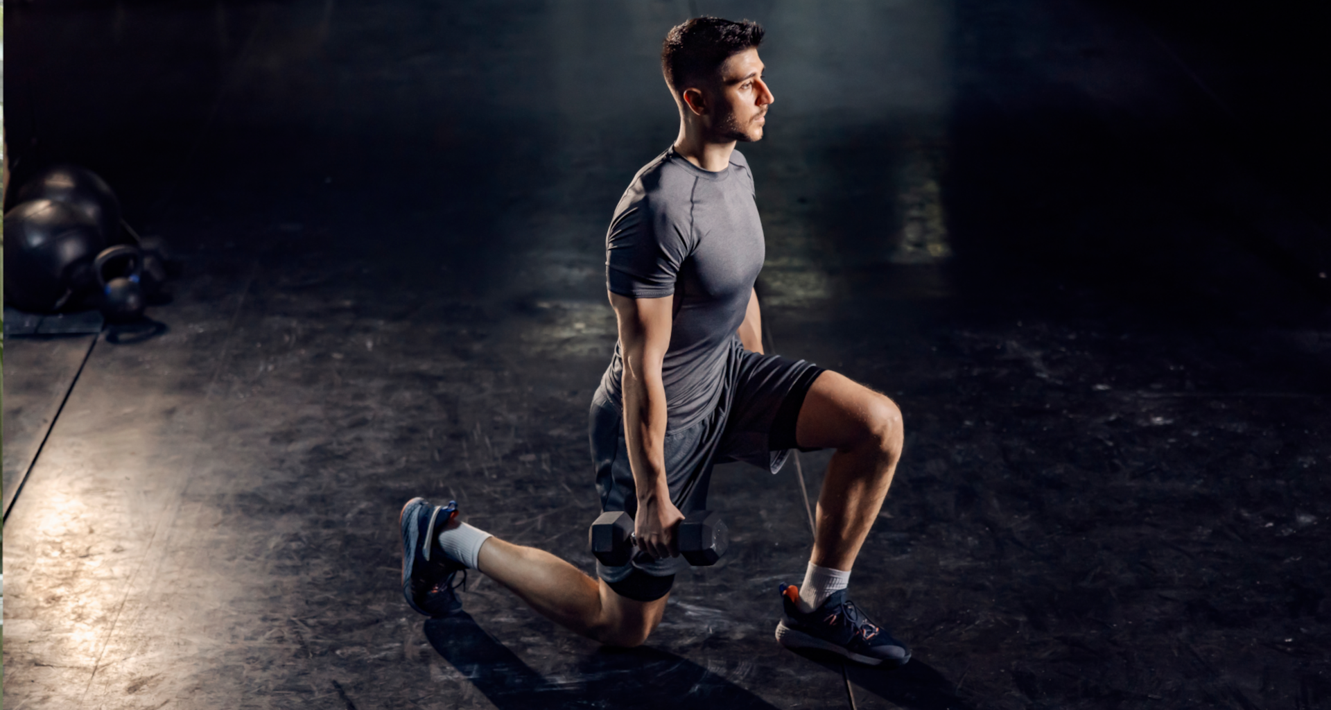 A man performing dumbbell lunges