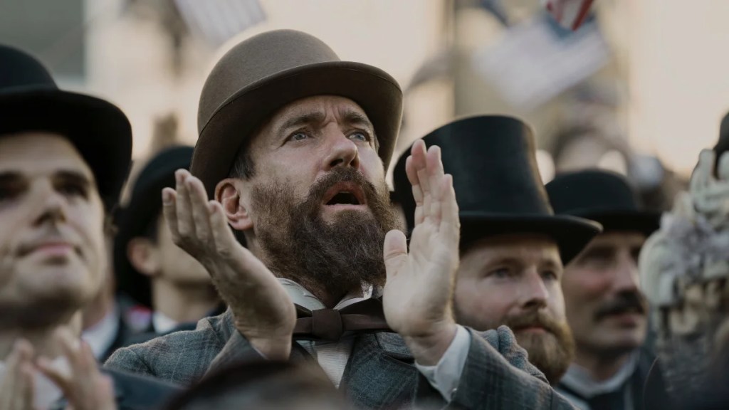 Matthew Macfadyen claps in a crowd in "Death by Lightning" (Netflix)