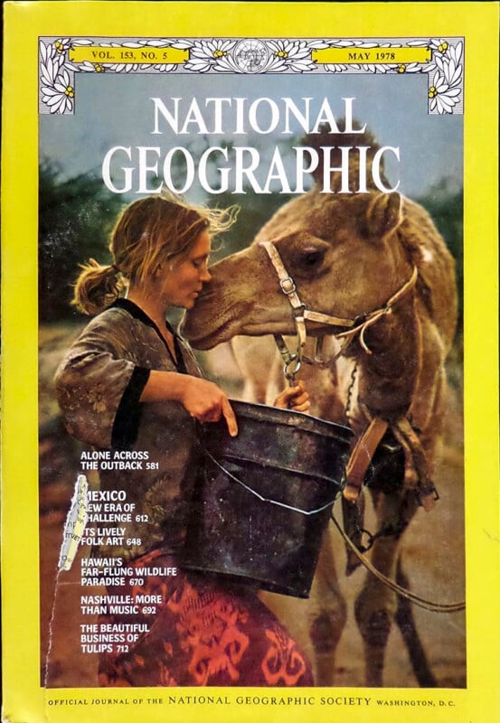 A woman holds a black bucket and nuzzles a camel on the cover of a May 1978 National Geographic magazine. The yellow border frames feature article titles and the magazine’s name.