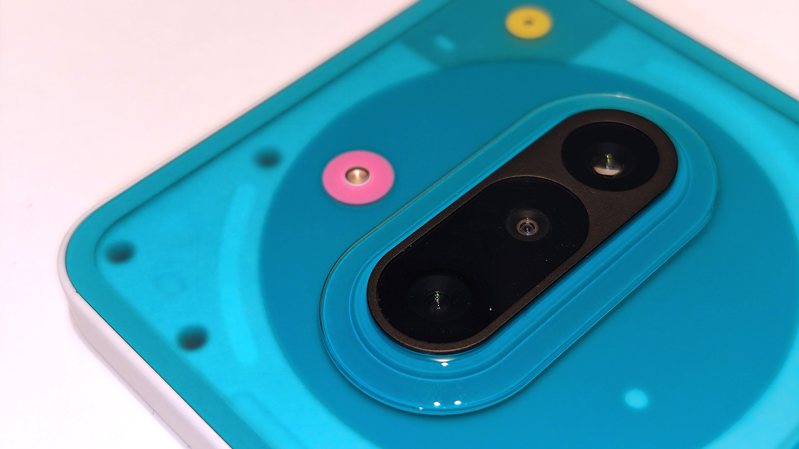 Nothing 3a Community Edition, a green phone on a white table