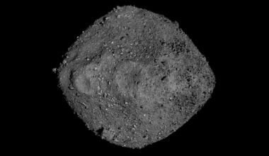 a ball of grey boulders and rocks seen against the blackness of space
