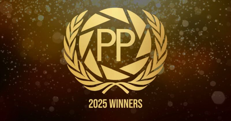 Gold laurel wreath around geometric design with the letters "PP" in the center, above the text "2025 WINNERS," on a sparkling, festive background.