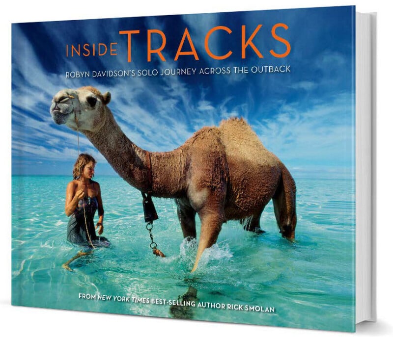 Book cover for "Inside Tracks" shows a woman standing in turquoise water beside a saddled camel under a blue sky. Text reads: "Robyn Davidson’s Solo Journey Across the Outback" by Rick Smolan.