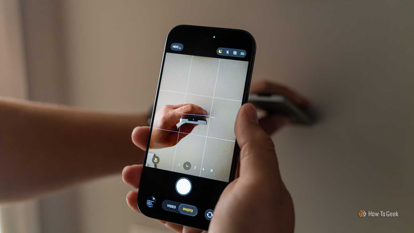 An iPhone 17 Pro's camera looking at a sound bar remote showing the IR LED illuminated.