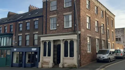 LDRS 176 High Street West in Sunderland. It is a Grade II-listed building that is Georgian style with white columns. It is next to a shop called Sonny's and Pop Recs, in Sunderland. 