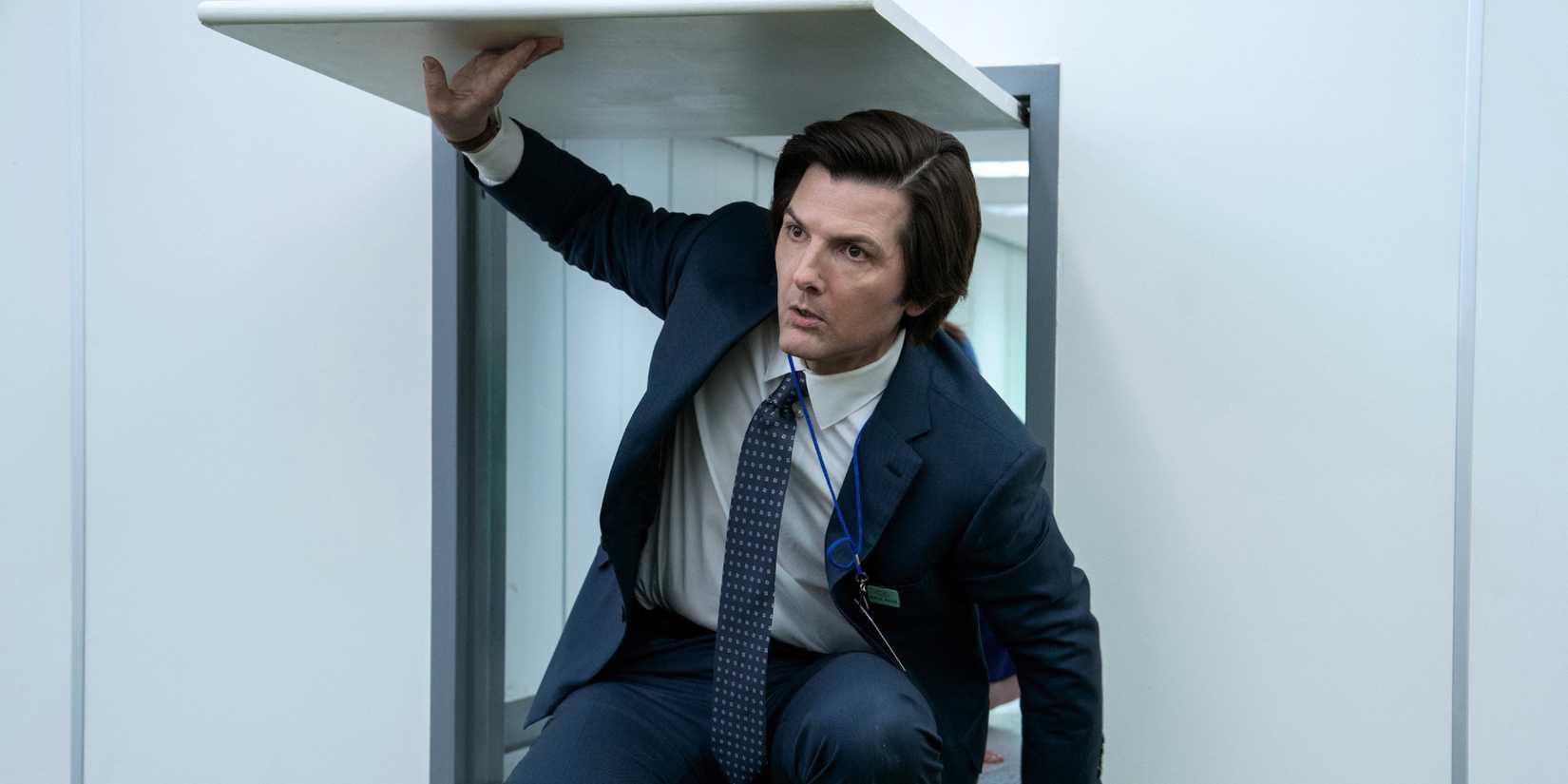 Adam Scott as Mark coming out of a small door in Severance