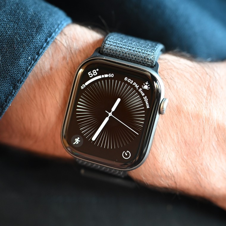 A close-up image of an Apple Watch Series 11 on the wrist of the writer.