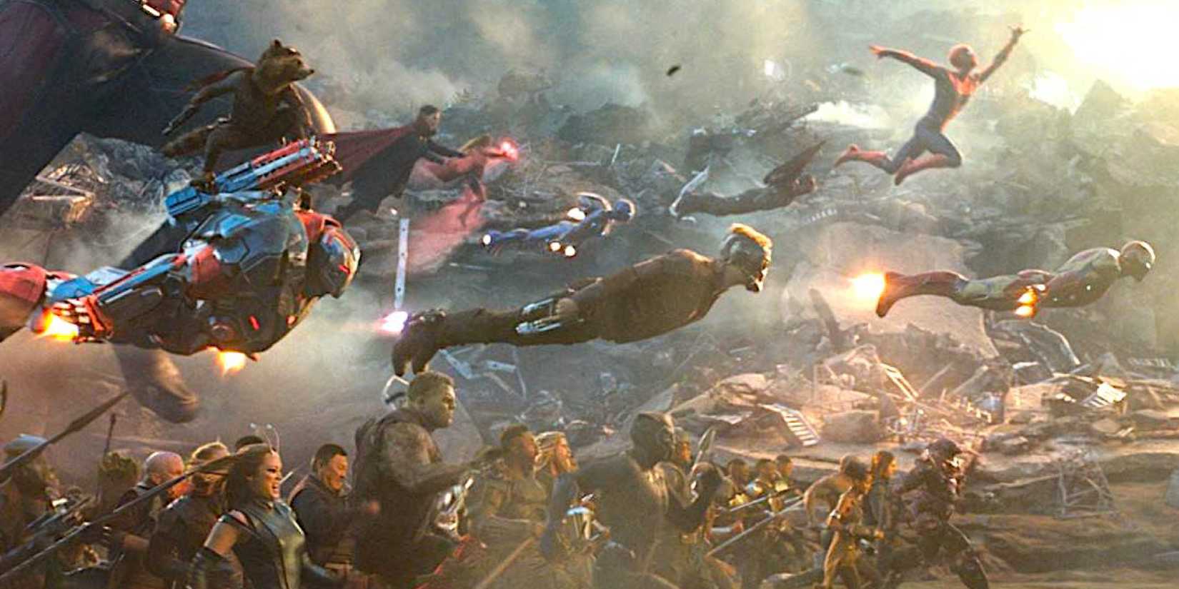 Avengers and a large host of other superheros charge en masse amid wreckage in Avengers: Endgame.