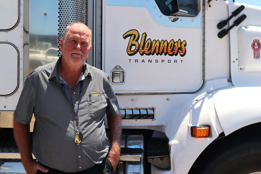 Les Blennerhassett stands in front of one of his Blenners transport trucks.