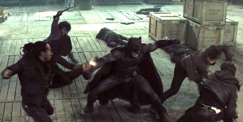Batman fighting multiple gunmen in a warehouse in Batman v Superman: Dawn of Justice.