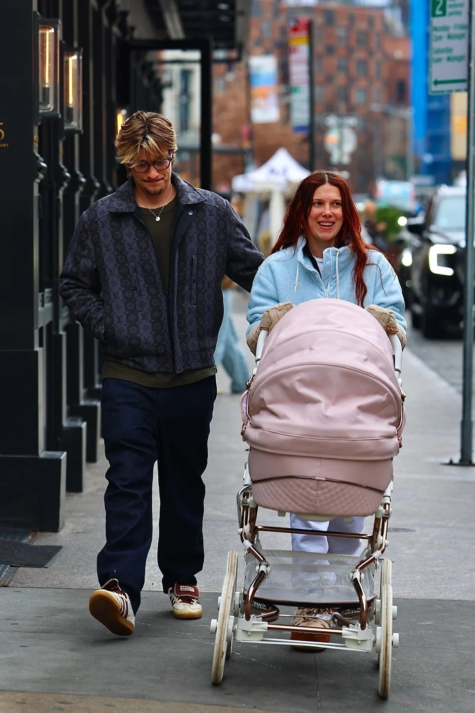 *exclusive* new york, ny **web must call for pricing** millie bobby brown, now known as millie bonnie bongiovi, and husband jake bonjovi were seen this afternoon in the west village, shopping at golden goose while strolling their daughter in a large pink stroller. milie was cozied up wearing chloe x moon boots and pushing their pink cartridge. jake showed off his blonde locks as he grabbed coffee for him and millie. pictured: millie bobby brown, jake bongiovi backgrid usa 10 december 2025 byline must read: blayzenphotos / backgrid usa: +1 310 798 9111 / usasales@backgrid.com uk: +44 208 344 2007 / uksales@backgrid.com *uk clients pictures containing children please pixelate face prior to publication*