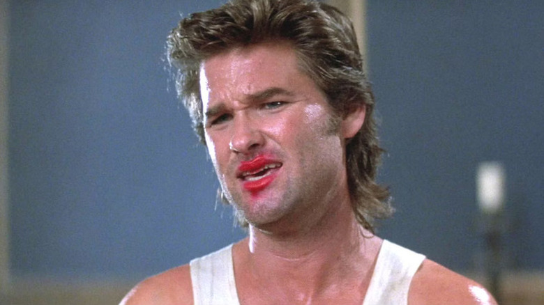 Jack Burton (Kurt Russell) looks incredulous with red lipstick on his mouth in Big Trouble in Little China