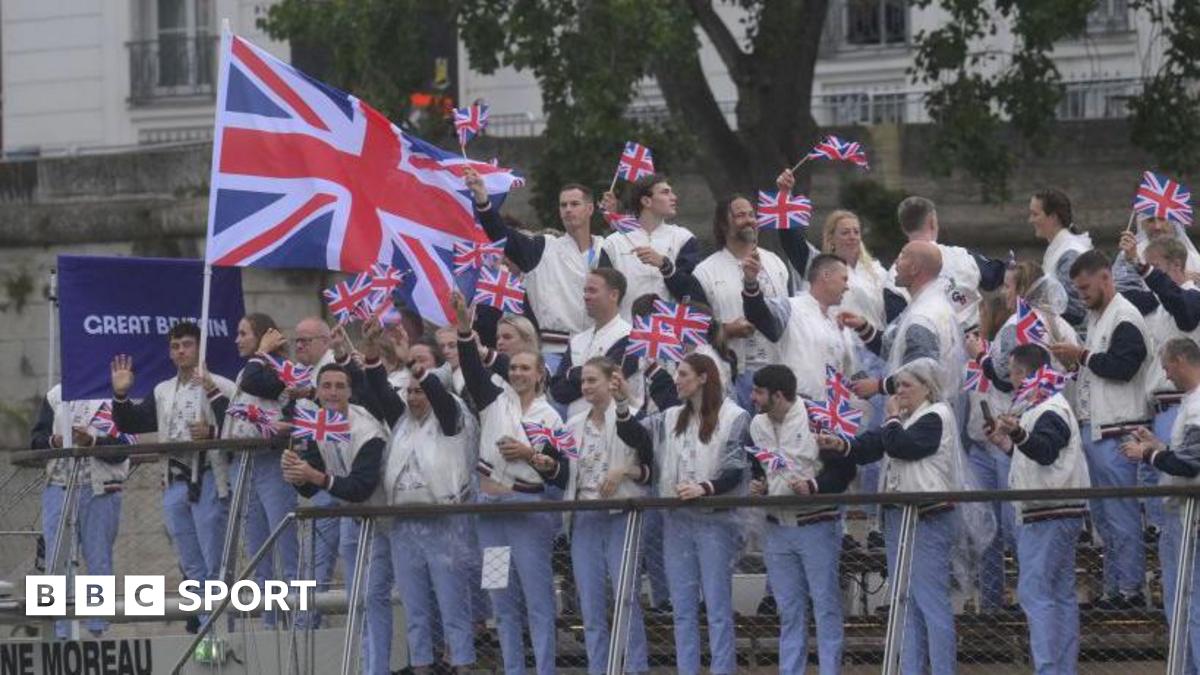 Team GB athletes wave from a boat sailing down the River Seine at the 2024 Paris Olympic Games opening ceremony