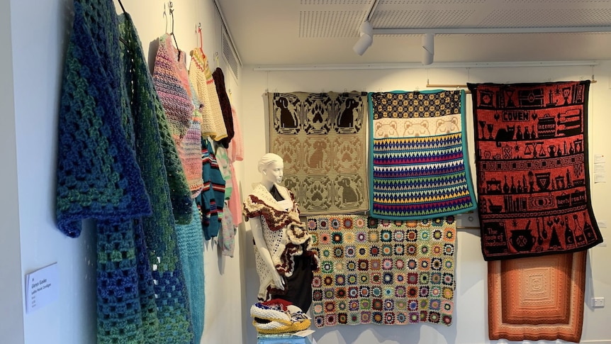 A gallery wall covered in stitching work done by local artists. 