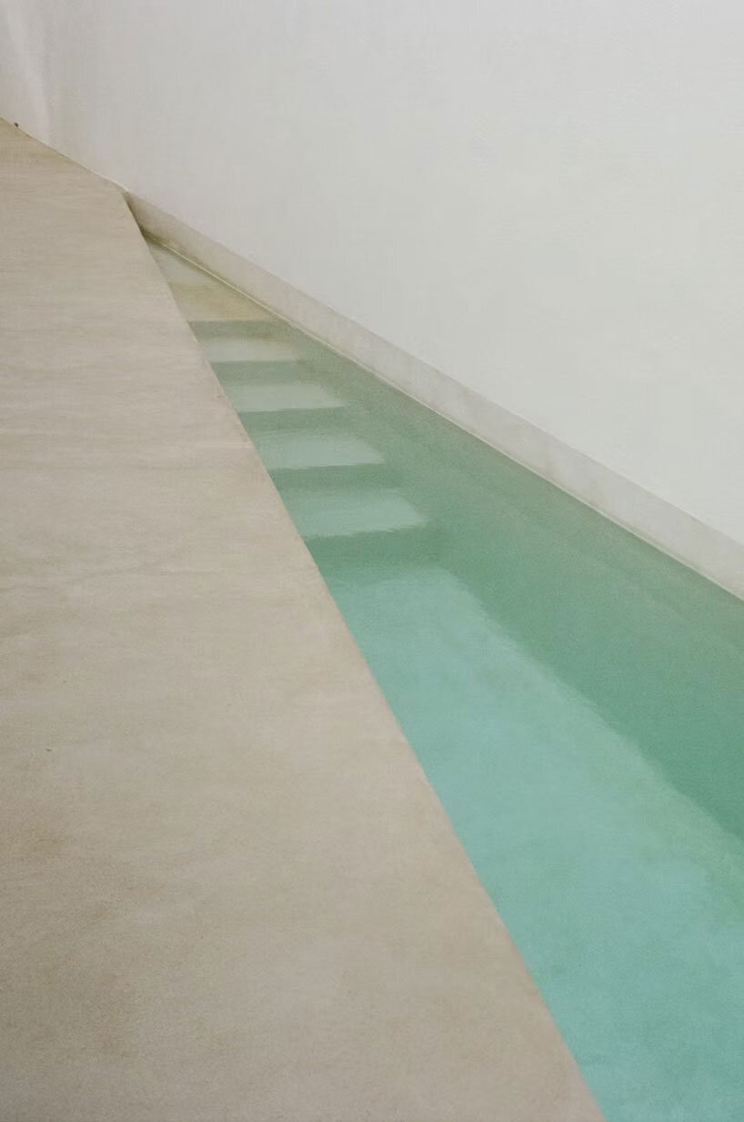 white louvers craft perforated facade filtering daylight within casa nada’s interiors in mexico