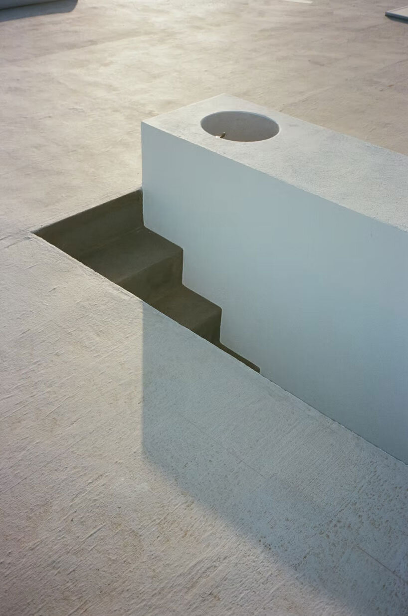 white louvers craft perforated facade filtering daylight within casa nada’s interiors in mexico