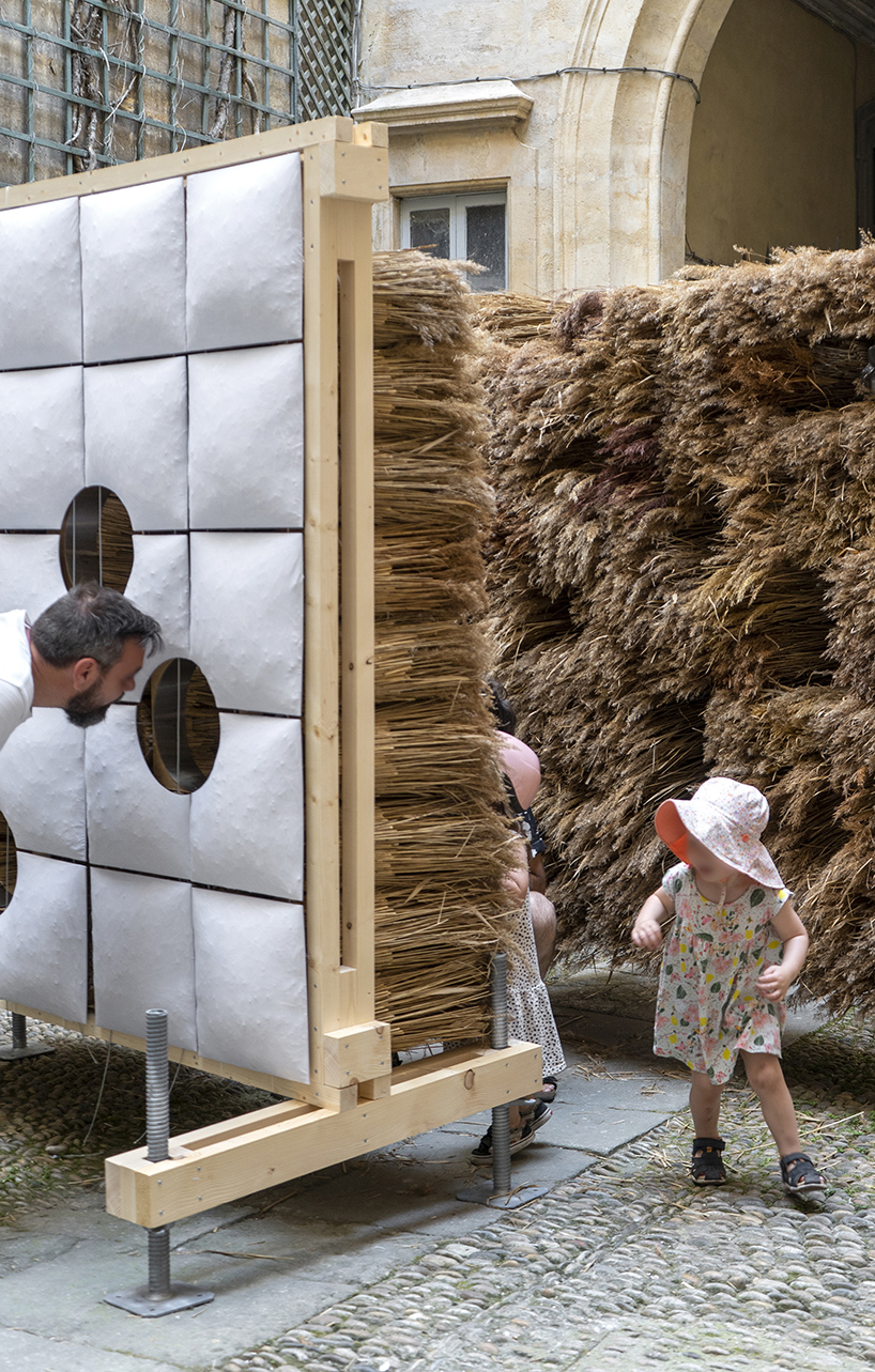 mirroring pillowed walls filled with reed grass compose sensory installation in montpellier