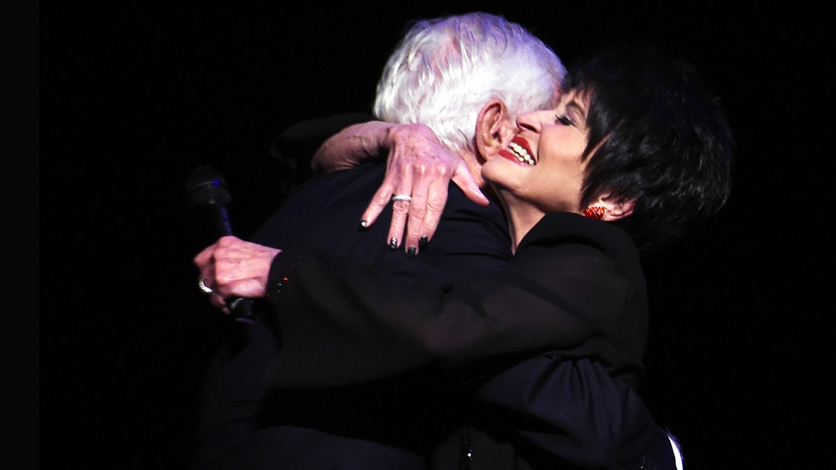 Chita Rivera embracing Dick Van Dyke.