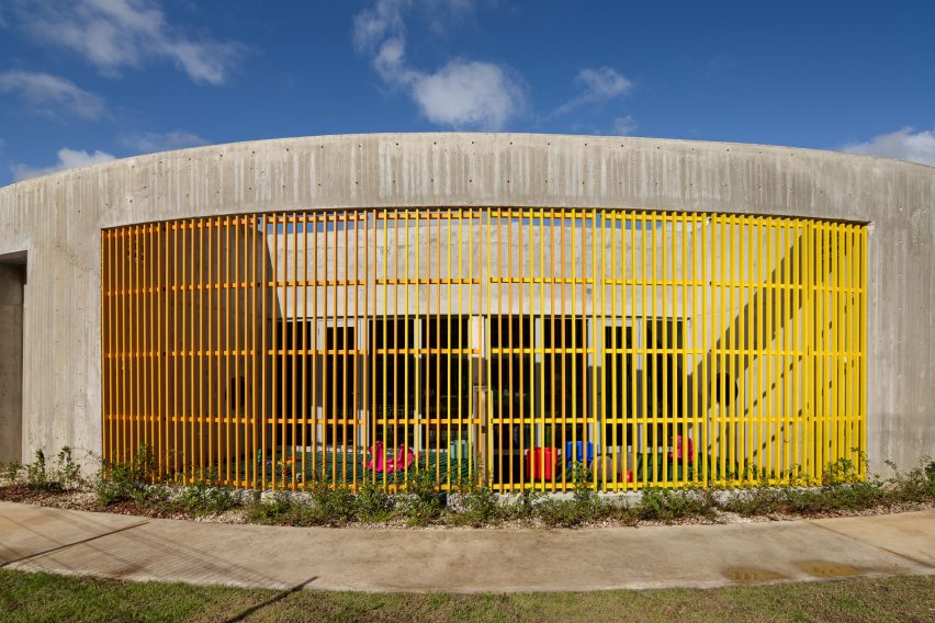 Concrete building with wall of yellow louvres