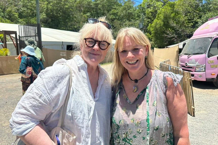 Two ladies smiling at the camera at the musical festival 