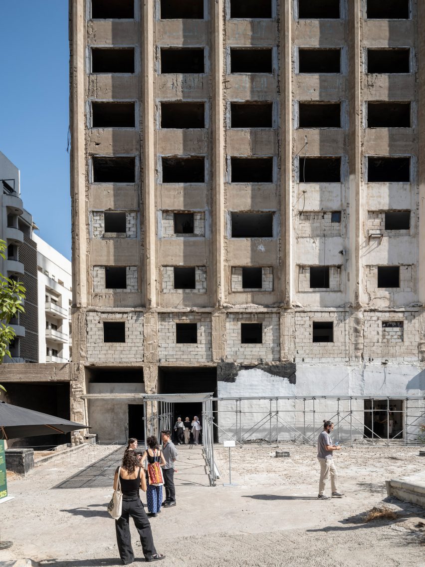 Photo of the front of the Burj El Murr building in Beirut at ground level with people approaching an entrance set up for an event