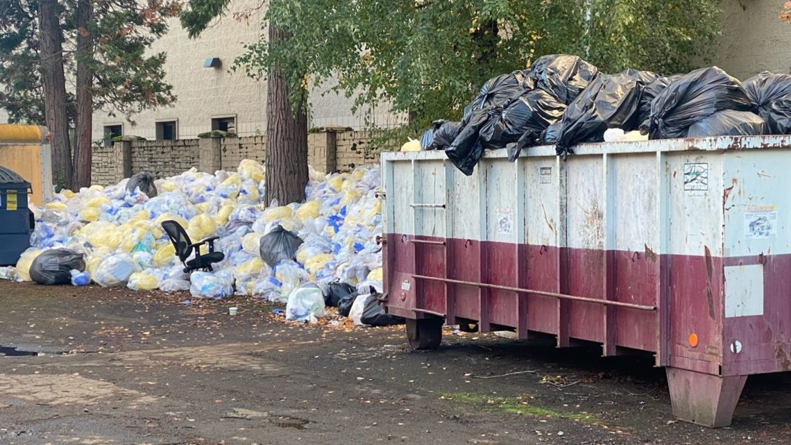 Heaps of trash bags left outside soon-to-be shuttered Portland hospital