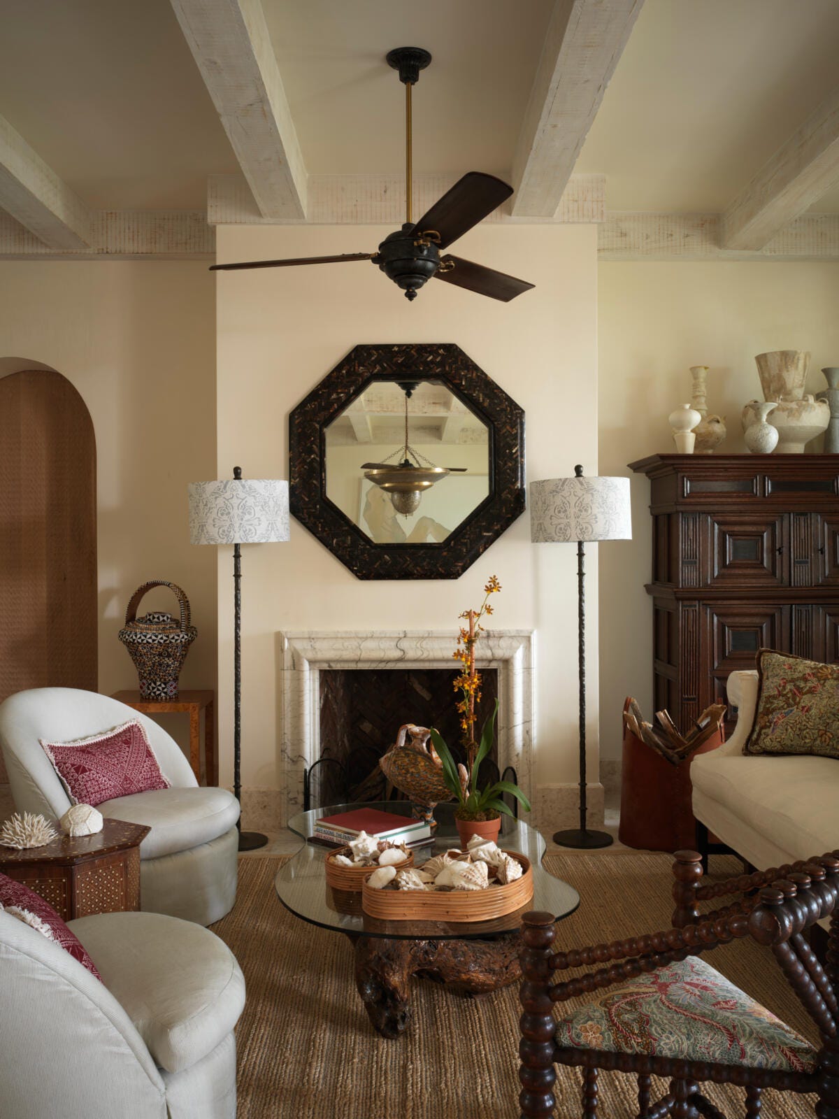 Photograph of a sitting room with various furniture and a fireplace.