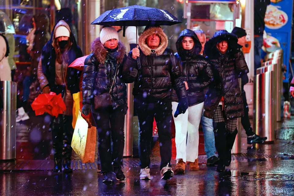 Snow and rain falls as people visit a dark and stormy New York City’s Times Square in January 2024. Many people take vitamin D supplements during the cold and dark winter months, but taking too much can cause serious health issues (AFP via Getty Images)