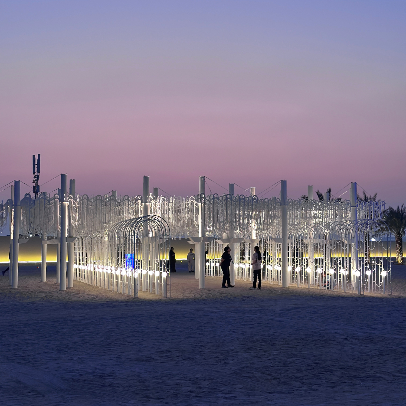 cloud-like white canopy of hanging vines emerges from abu dhabi’s arid landscape