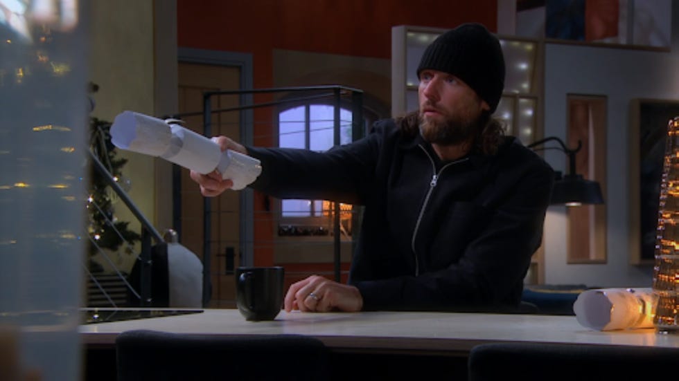 person holding a party popper above a table with a mug