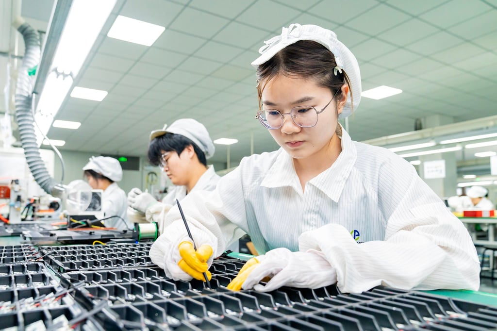 Workers make lithium batteries for domestic and international clients in a factory in Jiangsu. Photo: Getty