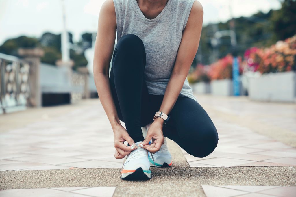 Running shoes. Woman tying shoe laces. 
