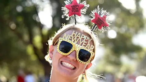 EPA Molly Taylor-South from the UK poses for a photograph ahead of the fireworks display during New Year's Eve festivities