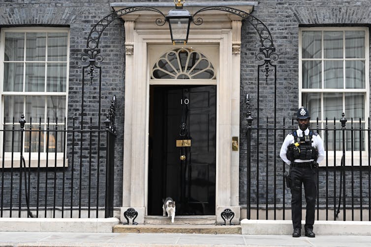 The black door and brick exterior of 10 Downing Street in London