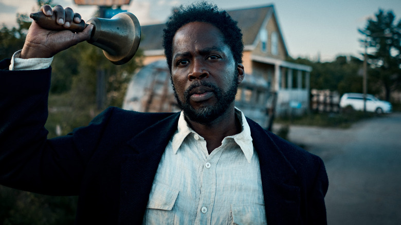 Boyd ringing a bell in town in From